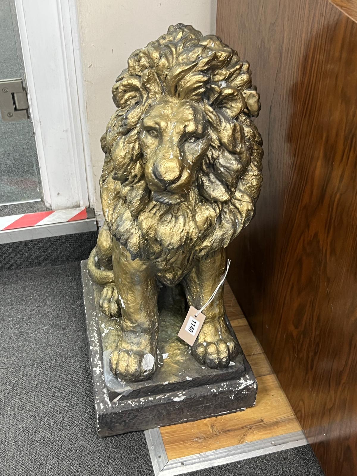 A painted composition faux stone lion garden ornament, height 65cm